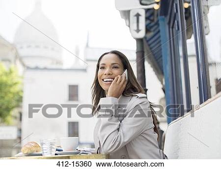 Businesswoman on cell phone at sidewalk cafe near Sacre Coeur Basilica, Paris, France View Large Photo Image Stock Image - Businesswoman on cell phone at sidewalk cafe near Sacre Coeur Basilica, Paris, France. Fotosearch
