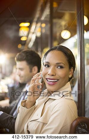 Businesswoman on cell phone at sidewalk cafe View Large Photo Image Stock Photo - Businesswoman on cell phone at sidewalk cafe. Fotosearch