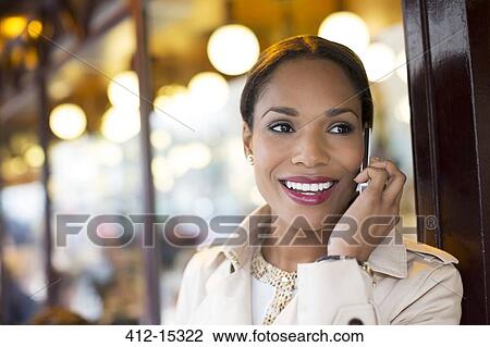 Businesswoman talking on cell phone at sidewalk cafe View Large Photo Image Stock Image - Businesswoman talking on cell phone at sidewalk cafe. Fotosearch