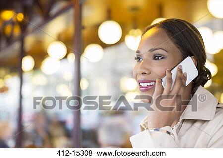 Businesswoman talking on cell phone at sidewalk cafe View Large Photo Image Stock Photo - Businesswoman talking on cell phone at sidewalk cafe. Fotosearch