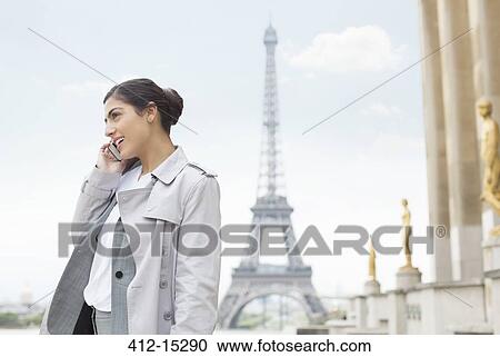 Businesswoman talking on cell phone by Eiffel Tower, Paris, France View Large Photo Image Stock Image - Businesswoman talking on cell phone by Eiffel Tower, Paris, France. Fotosearch