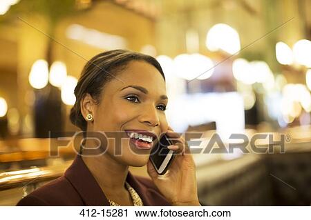 Businesswoman talking on cell phone in restaurant View Large Photo Image Stock Image - Businesswoman talking on cell phone in restaurant. Fotosearch