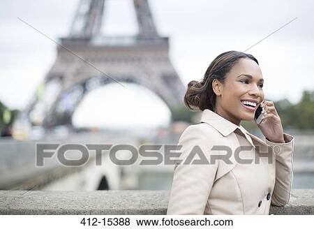 Businesswoman talking on cell phone near Eiffel Tower, Paris, France View Large Photo Image Stock Photo - Businesswoman talking on cell phone near Eiffel Tower, Paris, France. Fotosearch