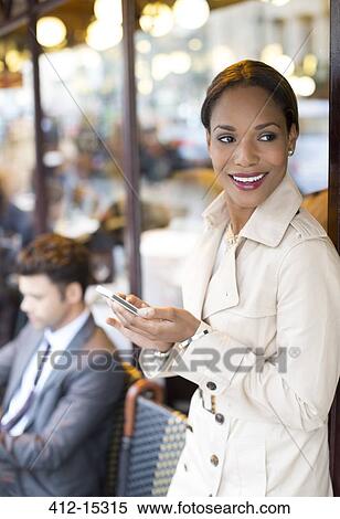 Businesswoman using cell phone at sidewalk cafe View Large Photo Image Stock Photography - Businesswoman using cell phone at sidewalk cafe. Fotosearch