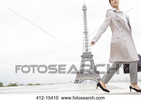 Businesswoman walking past Eiffel Tower, Paris, France View Large Photo Image Stock Image - Businesswoman walking past Eiffel Tower, Paris, France. Fotosearch