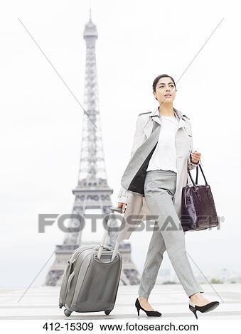 Businesswoman walking past Eiffel Tower, Paris, France View Large Photo Image Stock Photo - Businesswoman walking past Eiffel Tower, Paris, France. Fotosearch