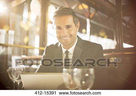 Stock Image - Man using digital tablet in restaurant. Fotosearch