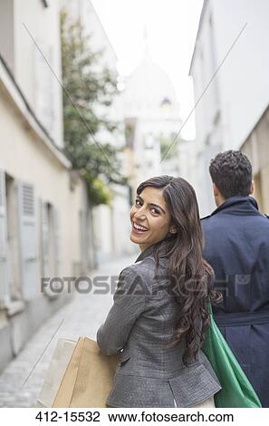 Couple carrying shopping bags in street near Sacre Coeur Basilica, Paris, France View Large Photo Image Stock Image - Couple carrying shopping bags in street near Sacre Coeur Basilica, Paris, France. Fotosearch