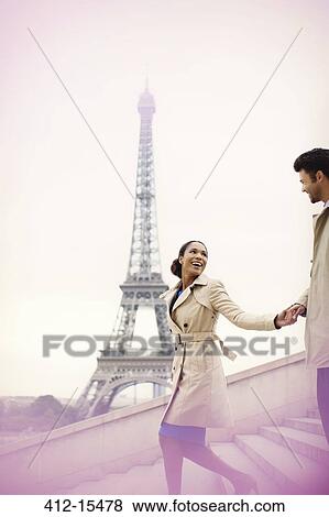 Couple descending stairs by Eiffel Tower, Paris, France View Large Photo Image Stock Photo - Couple descending stairs by Eiffel Tower, Paris, France. Fotosearch