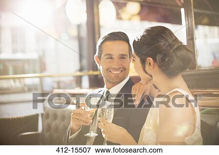 Stock Photo - Couple drinking champagne in restaurant. Fotosearch