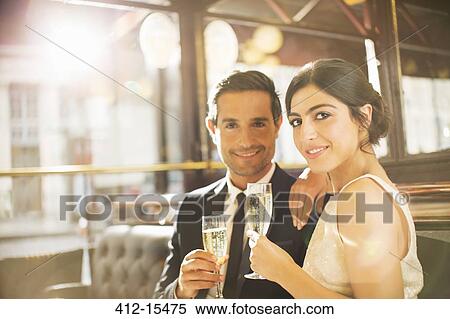 Couple drinking champagne in restaurant View Large Photo Image Stock Photography - Couple drinking champagne in restaurant. Fotosearch
