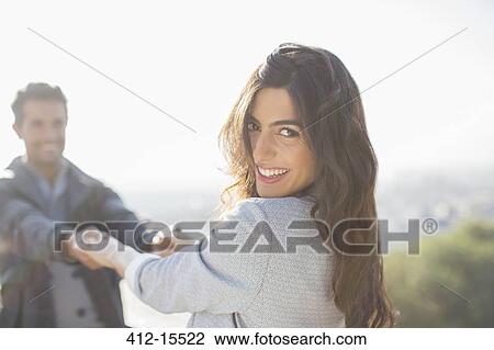 Couple holding hands with arms outstretched outdoors View Large Photo Image Stock Image - Couple holding hands with arms outstretched outdoors. Fotosearch
