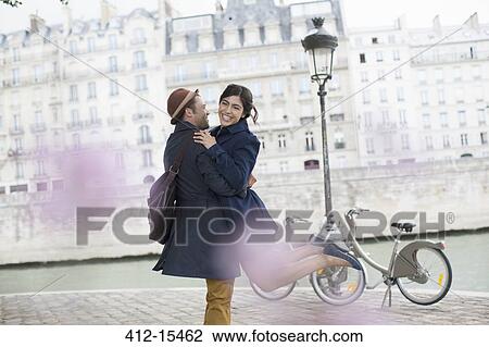 Couple hugging along Seine River, Paris, France View Large Photo Image Stock Image - Couple hugging along Seine River, Paris, France. Fotosearch