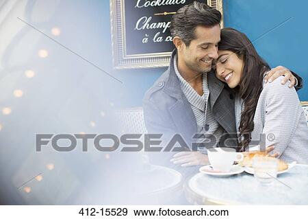 Couple hugging at sidewalk cafe in Paris, France View Large Photo Image Stock Photo - Couple hugging at sidewalk cafe in Paris, France. Fotosearch