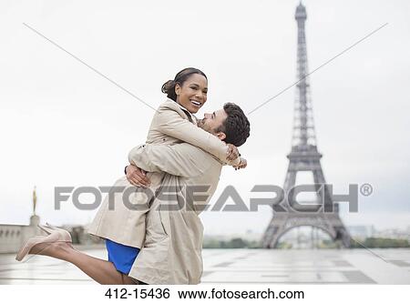 Couple hugging by Eiffel Tower, Paris, France View Large Photo Image Stock Photograph - Couple hugging by Eiffel Tower, Paris, France. Fotosearch