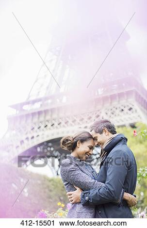 Couple hugging in front of Eiffel Tower, Paris, France View Large Photo Image Stock Image - Couple hugging in front of Eiffel Tower, Paris, France. Fotosearch