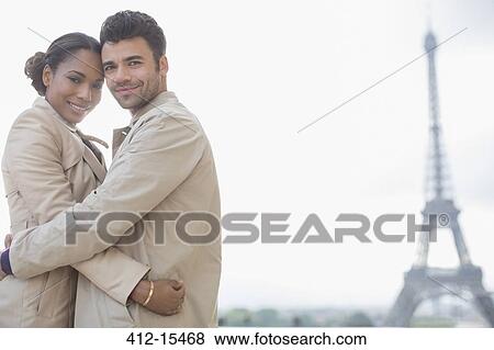 Couple hugging in front of Eiffel Tower, Paris, France View Large Photo Image Stock Photo - Couple hugging in front of Eiffel Tower, Paris, France. Fotosearch