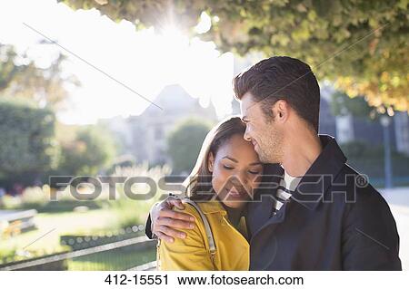 Couple hugging in urban park View Large Photo Image Stock Image - Couple hugging in urban park. Fotosearch