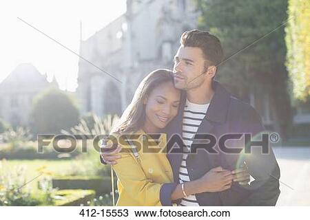 Couple hugging in urban park View Large Photo Image Stock Image - Couple hugging in urban park. Fotosearch