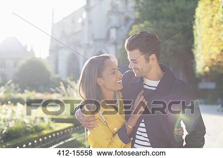 Couple hugging in urban park View Large Photo Image Stock Photo - Couple hugging in urban park. Fotosearch