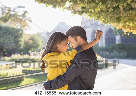 Couple hugging in urban park View Large Photo Image Stock Photography - Couple hugging in urban park. Fotosearch