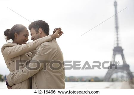 Couple hugging near Eiffel Tower, Paris, France View Large Photo Image Stock Photograph - Couple hugging near Eiffel Tower, Paris, France. Fotosearch