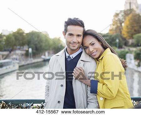 Couple hugging on Pont des Arts bridge over Seine River, Paris, France View Large Photo Image Stock Photo - Couple hugging on Pont des Arts bridge over Seine River, Paris, France. Fotosearch