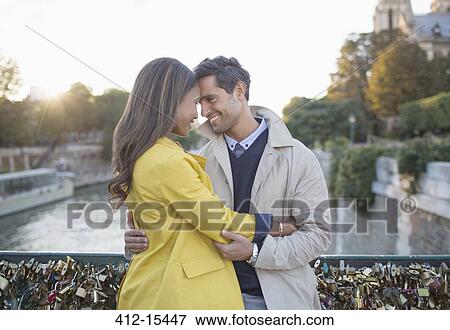 Stock Photo - Couple hugging on Pont des Arts, Paris, France. Fotosearch