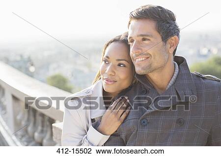 Stock Image - Couple hugging outdoors. Fotosearch
