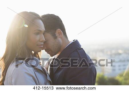 Couple hugging outdoors View Large Photo Image Stock Image - Couple hugging outdoors. Fotosearch