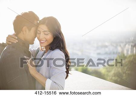Couple hugging outdoors View Large Photo Image Stock Photograph - Couple hugging outdoors. Fotosearch
