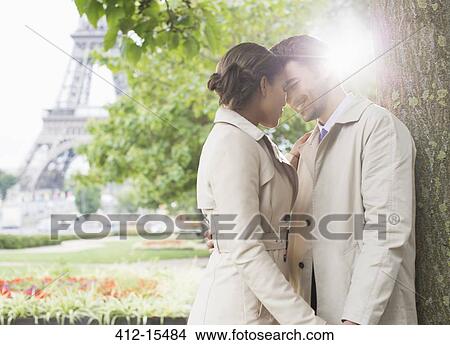 Couple kissing in park near Eiffel Tower, Paris, France View Large Photo Image Picture - Couple kissing in park near Eiffel Tower, Paris, France. Fotosearch