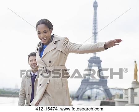 Couple walking in front of Eiffel Tower, Paris, France View Large Photo Image Picture - Couple walking in front of Eiffel Tower, Paris, France. Fotosearch