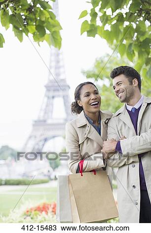 Stock Image - Couple walking in park near Eiffel Tower, Paris, France. Fotosearch