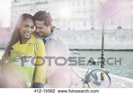 Couple with bouquet of flowers by Seine River, Paris, France View Large Photo Image Stock Image - Couple with bouquet of flowers by Seine River, Paris, France. Fotosearch