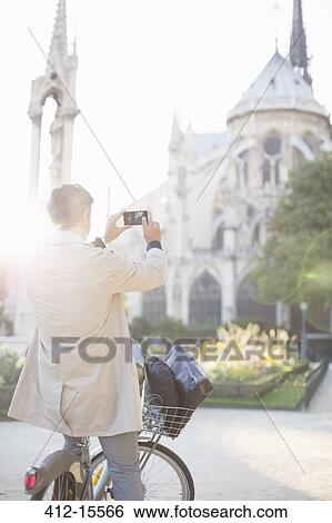 Man photographing Notre Dame Cathedral, Paris, France View Large Photo Image Stock Photograph - Man photographing Notre Dame Cathedral, Paris, France. Fotosearch