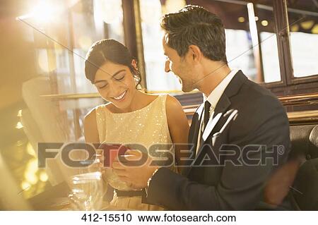 Stock Image - Man proposing to girlfriend in restaurant. Fotosearch
