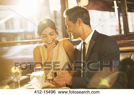 Stock Photograph - Man proposing to girlfriend in restaurant. Fotosearch