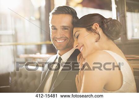 Well-dressed couple hugging in restaurant View Large Photo Image Stock Image - Well-dressed couple hugging in restaurant. Fotosearch