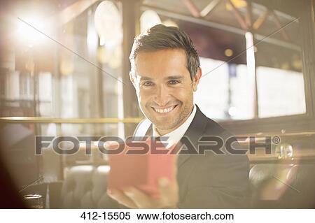 Well-dressed man holding jewelry box in restaurant View Large Photo Image Stock Photography - Well-dressed man holding jewelry box in restaurant. Fotosearch