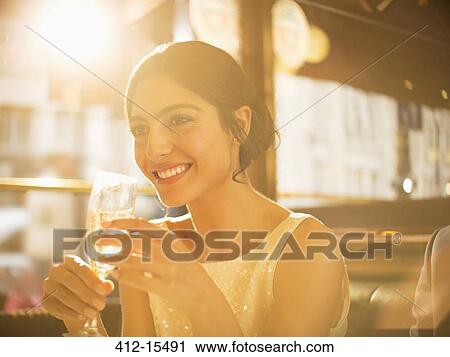 Well-dressed woman drinking champagne in restaurant View Large Photo Image Stock Image - Well-dressed woman drinking champagne in restaurant. Fotosearch