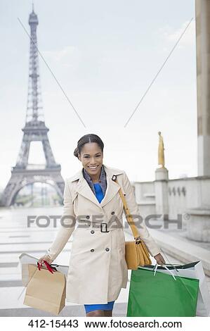 Woman carrying shopping bags by Eiffel Tower, Paris, France View Large Photo Image Stock Image - Woman carrying shopping bags by Eiffel Tower, Paris, France. Fotosearch