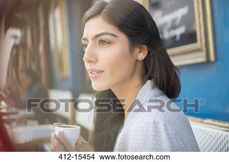 Woman drinking espresso at sidewalk cafe View Large Photo Image Picture - Woman drinking espresso at sidewalk cafe. Fotosearch