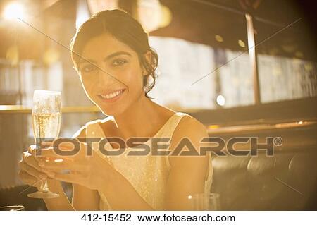 Woman having champagne in restaurant View Large Photo Image Stock Image - Woman having champagne in restaurant. Fotosearch