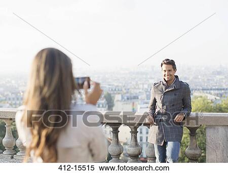 Woman photographing boyfriend with Paris in background View Large Photo Image Stock Photography - Woman photographing boyfriend with Paris in background. Fotosearch