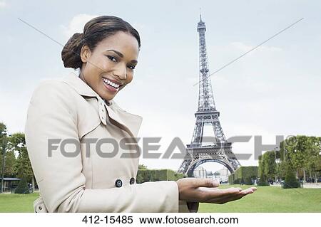Woman posing as if holding the Eiffel Tower in hands, Paris, France View Large Photo Image Stock Photography - Woman posing as if holding the Eiffel Tower in hands, Paris, France. Fotosearch