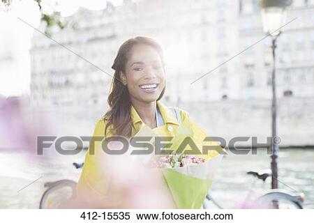 Woman with bouquet of flowers along Seine River, Paris, France View Large Photo Image Stock Photography - Woman with bouquet of flowers along Seine River, Paris, France. Fotosearch