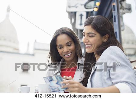 Women reading postcard at sidewalk cafe in Paris, France View Large Photo Image Stock Image - Women reading postcard at sidewalk cafe in Paris, France. Fotosearch
