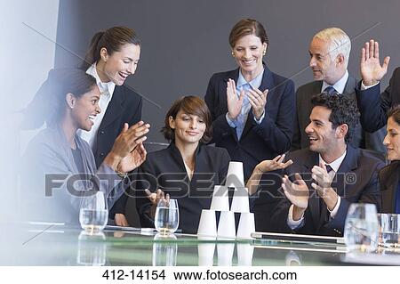Business people applauding colleague in meeting View Large Photo Image Picture - Business people applauding colleague in meeting. Fotosearch