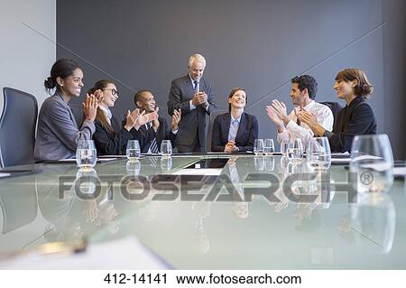 Business people applauding colleague in meeting View Large Photo Image Stock Image - Business people applauding colleague in meeting. Fotosearch